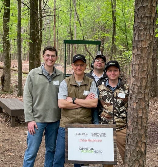 JAH attorneys posing at the JAH sponsored station at the Catawba Lands Conservancy 2024 Clays for Conservation Tournament. From left to right Will Fussy, J. McKeown, Ryan Less, Mathias Young.